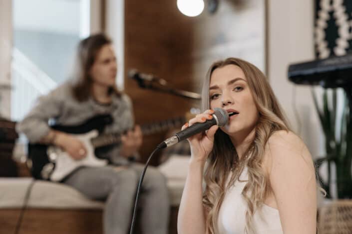 woman-in-white-tank-top-singing-stockpack-pexels