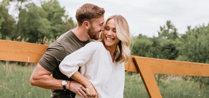 Couple giggling in the field