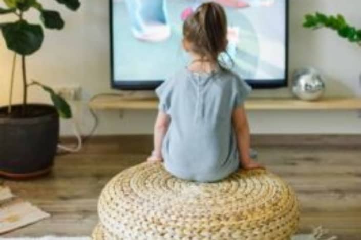 A Kid Watching a Program on TV.