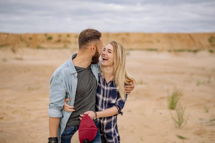 Smiling couple hugging in desert nature