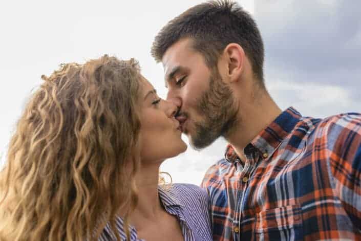 Woman and man kissing each other