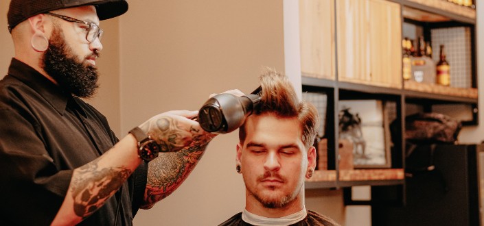 Barber Drying Hair of Male Client in Salon