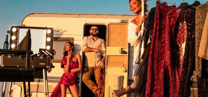 Man With Models Near Trailer and Fashionable Clothes