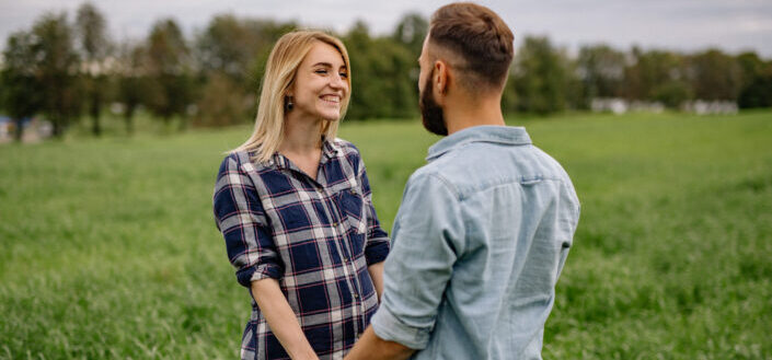 Couple enjoying their moments in a field of green grass