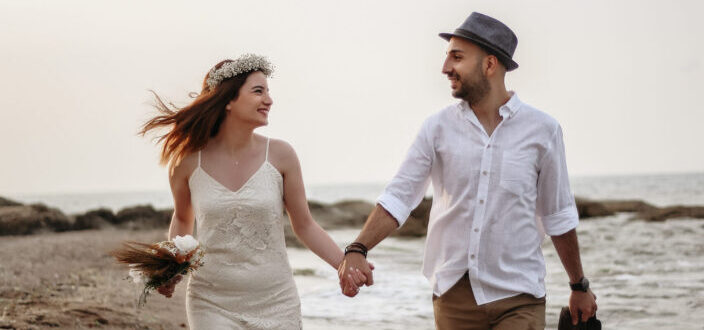 Happy couple walking on a seashore