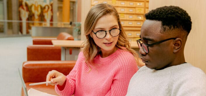 couple with glasses sitting on couch