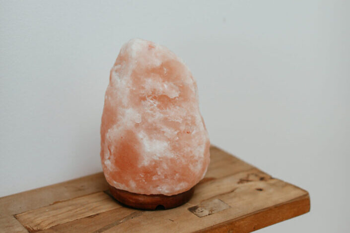 A Himalayan salt lamp on wooden plank