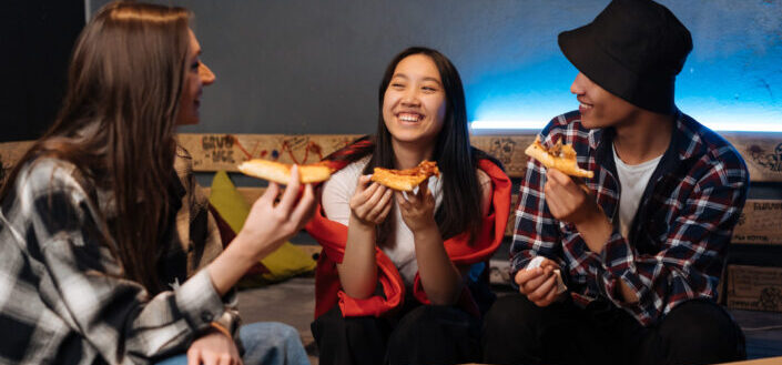 Teens Eating Pizza while Sitting