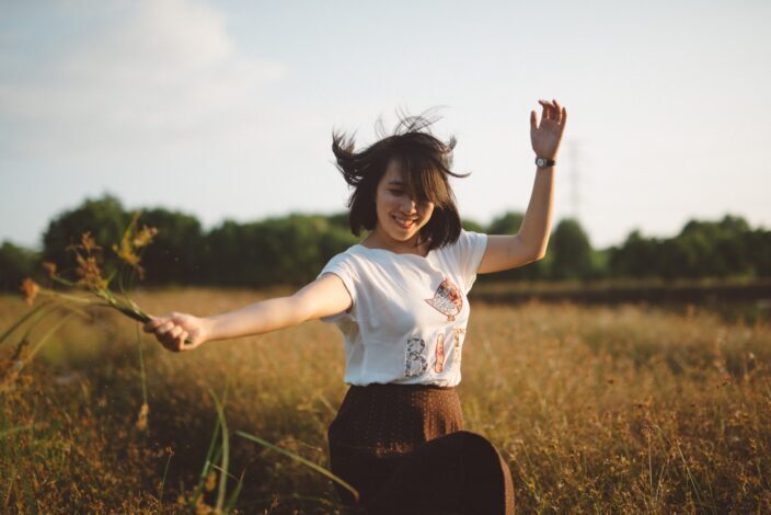 Woman dancing on an open field