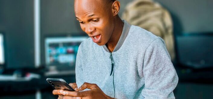 Man Excited on Looking at His Phone