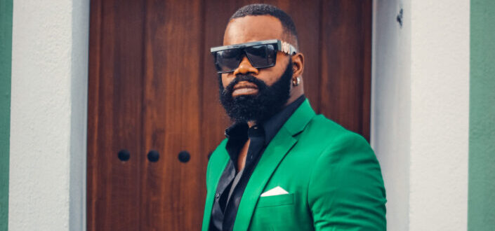 Man wearing sunglasses and a green suit