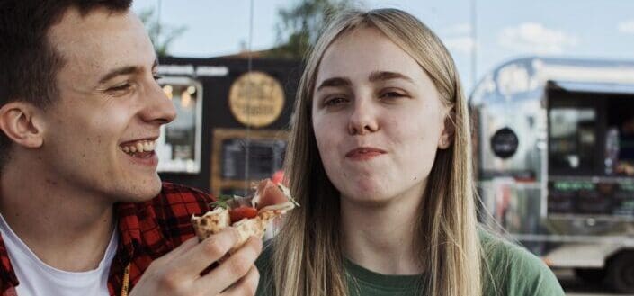 A couple eating pizza