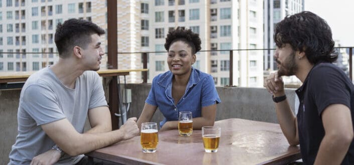 A group of friends having conversation at a roof deck