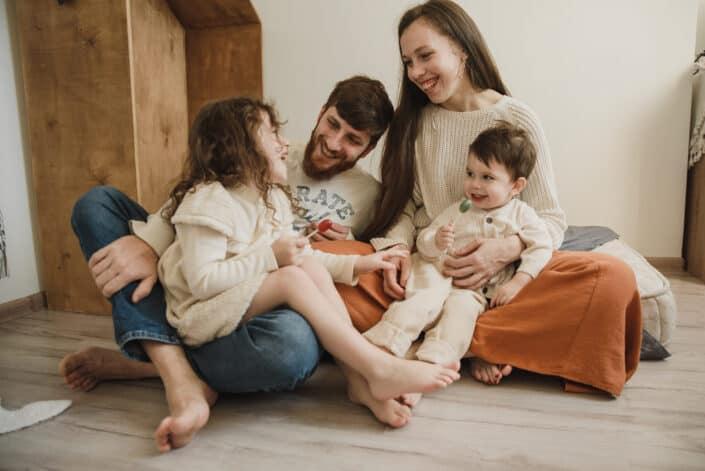 A happy family sitting together on the floor