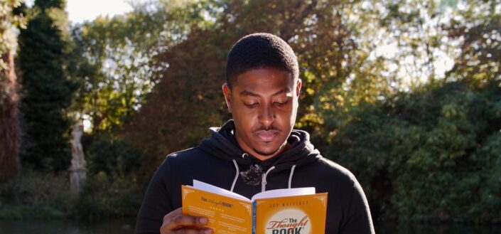 a man reading a book in the park