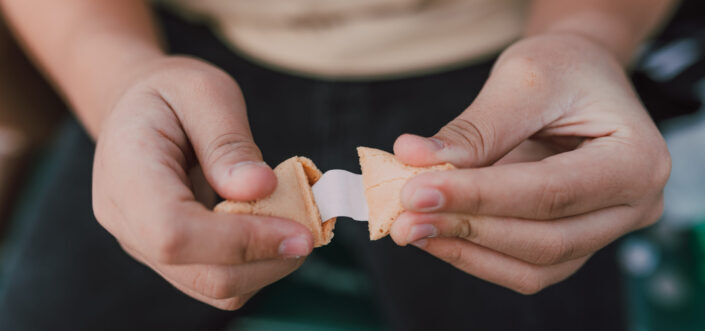 A person holding a fortune cookie