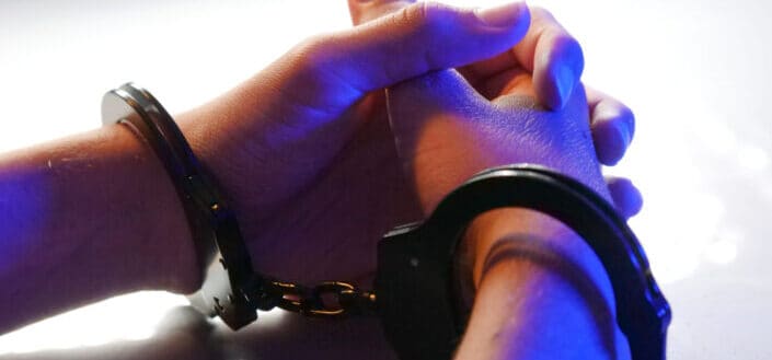 A person with black handcuffs