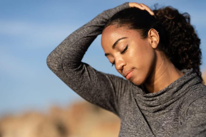 A woman posing with her eyes closed