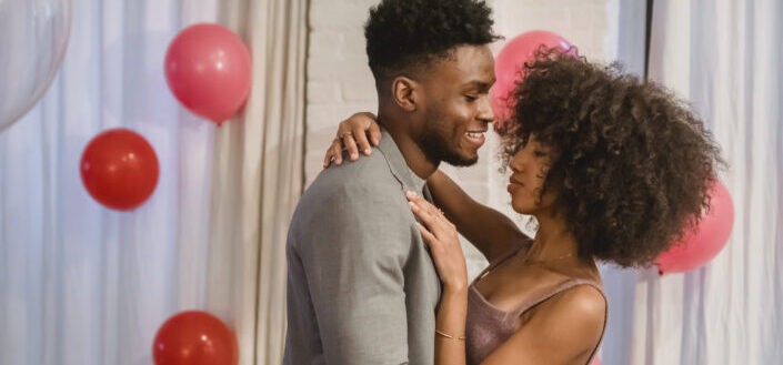 couple hugging and dancing in their apartment