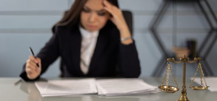 An exhausted lawyer reading the case paper