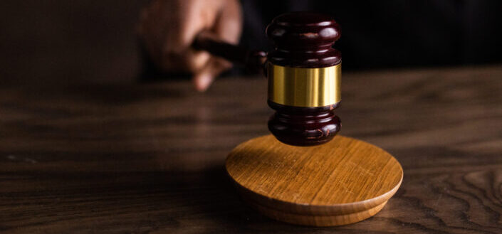 Brown wooden gavel on brown wooden table