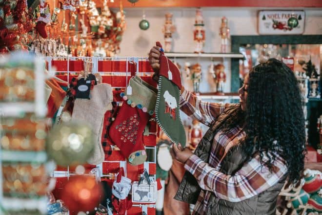 Cool Things to Get for Christmas - smiling woman choosing christmas decorations in store