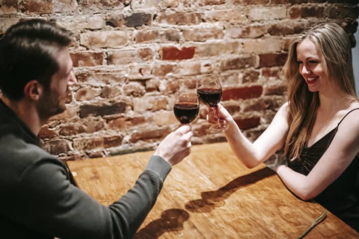 Couple Having Romantic Dinner Cheering With Wineglasses