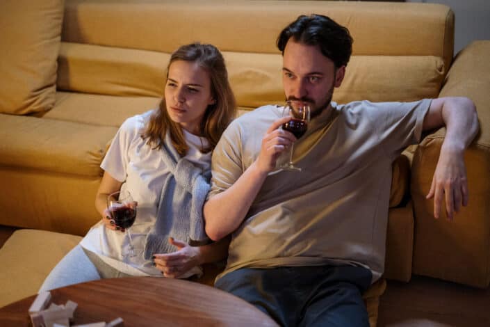 Couple sitting on the floor drinking wine
