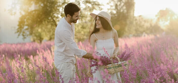 Couple picking lavender in field