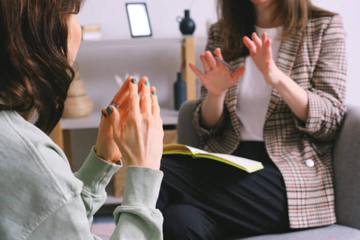 Female psychologist and patient having a therapy session