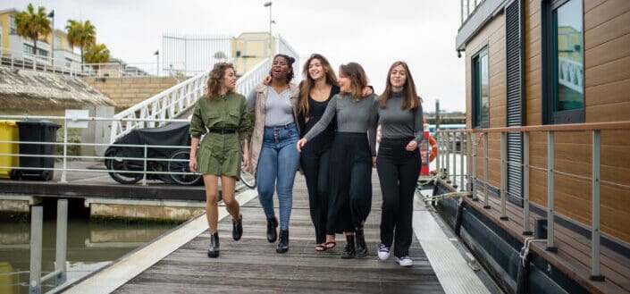 Group of women walking on boardwalk