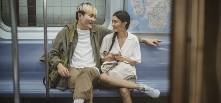 Young Couple Sitting in Train and Talking
