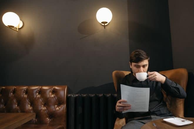 hard riddles for adults - man drinking coffee while reading a paper
