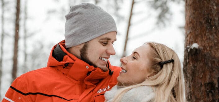 Loving couple hugging in winter forest
