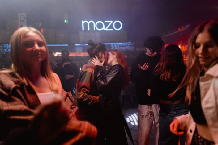 Man and woman kissing inside the night club