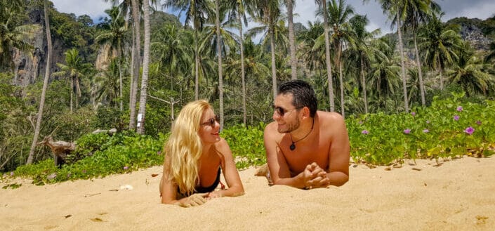 Man and woman lying on sand