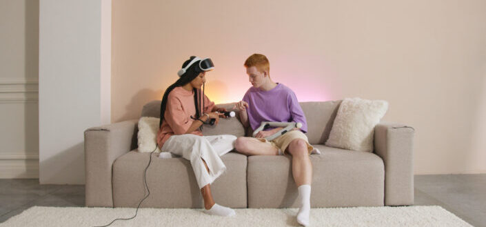Man and Woman Sitting on Brown Couch Playing Virtual Reality