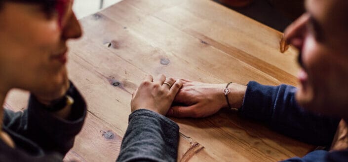 Man and woman sitting together in front of table