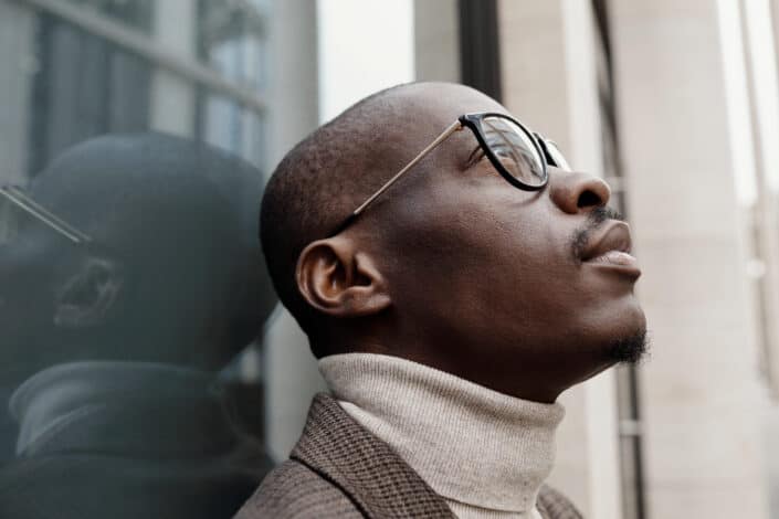 Man in white turtleneck looking up