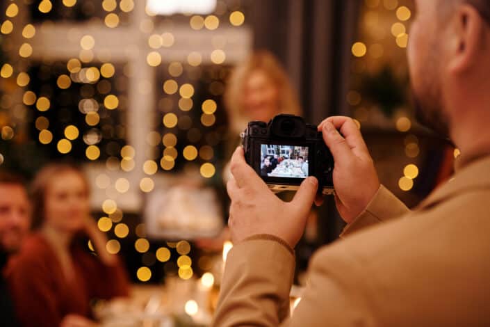 Man taking photos using black dslr camera