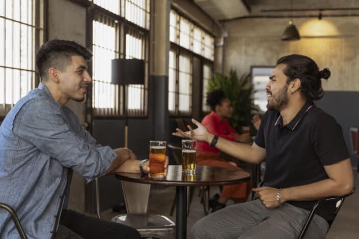 Men having conversation while looking at each other