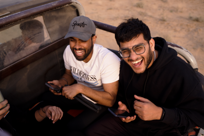 Men riding on jeep laughing