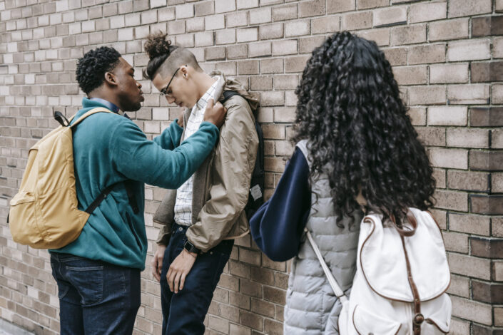 Multiracial students having argument on street