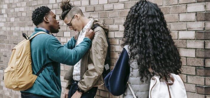 Multiracial students having argument on street