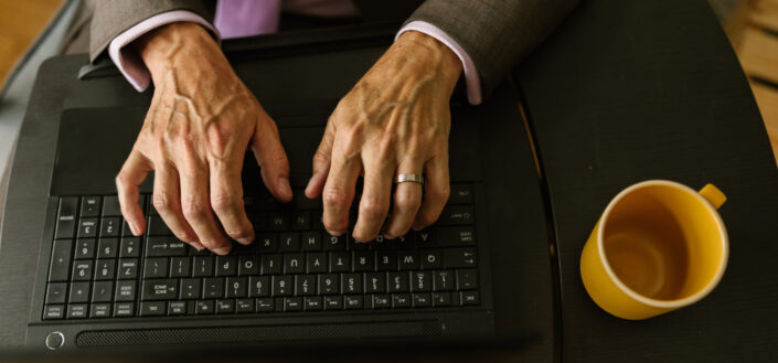 Person typing on black laptop computer