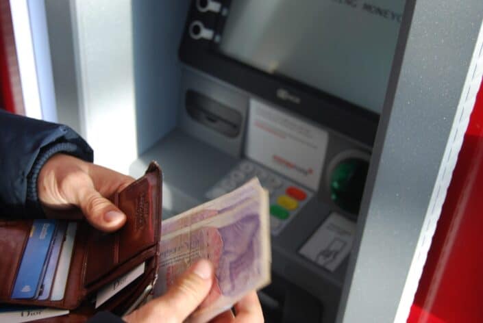 Person withdrawing money from UK ATM