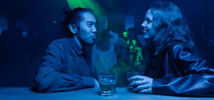 Man talking to woman in a club