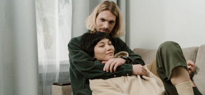 Man With Blond Hair Hugging a Woman