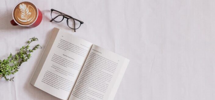 A book and eyeglass in white background