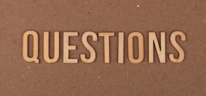 Questions cut out on cardboard